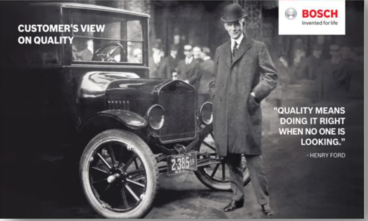 Wall branding: “Customer’s view on quality” — Henry Ford beside a Model T: “Quality means doing it right when no one is looking”
