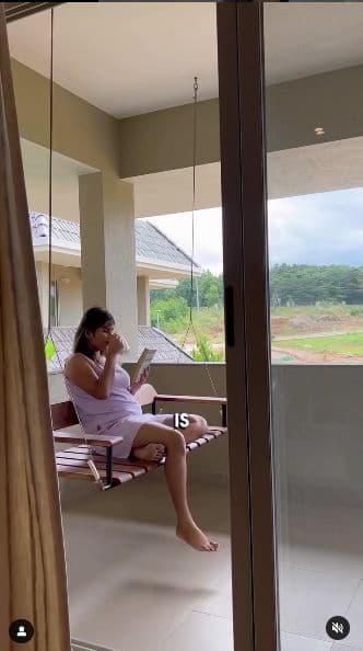 Influencer content: a guest reading on a veranda swing overlooking the grounds
