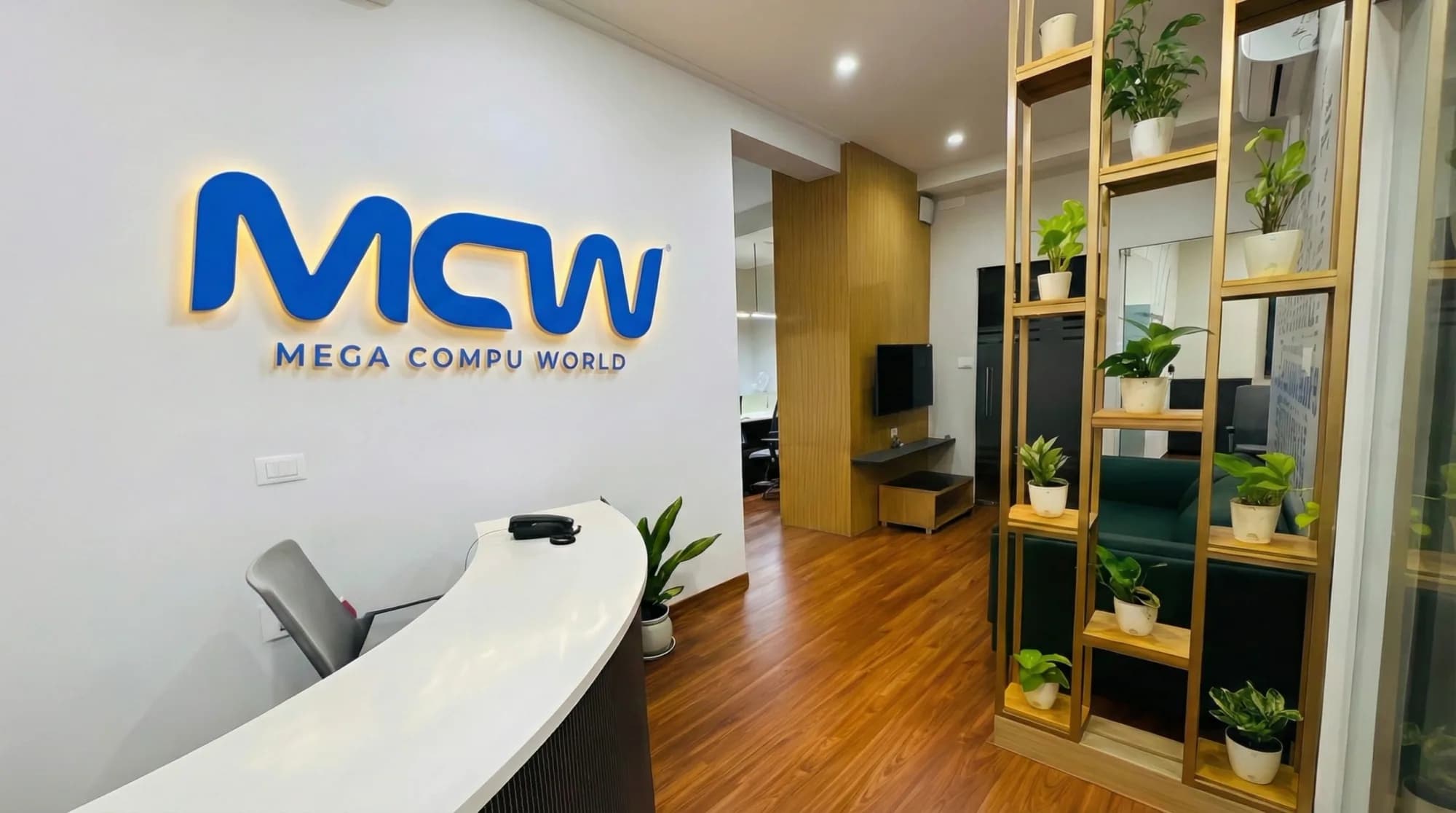 The MCW logo as backlit signage in Mega Compu World’s office reception
