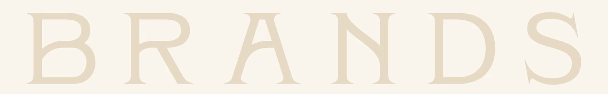 The word BRANDS in large, widely spaced serif capitals, in sand on a cream band